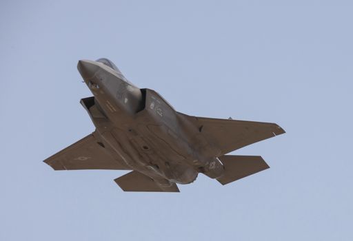 A Lockheed Martin F-35 Lightning II flying in a clear blue sky at Mather Air Force Base