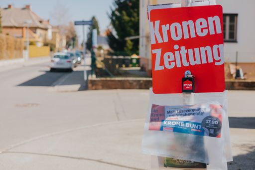 A closeup of the street stand of Austrian newspapers Kronen Zeitung. Klagenfurt, Austria.