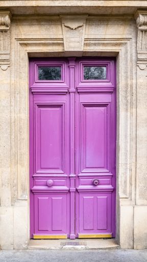 Paris, an ancient wooden door, colorful facade in the 11e arrondissement