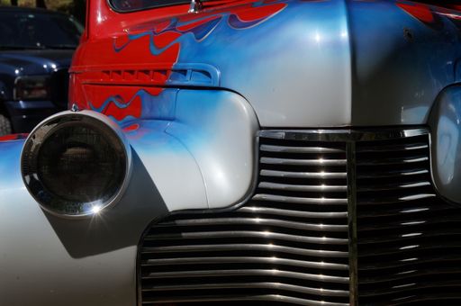 A close-up shot of red and blue painted hot rod car in bright sunlight in Grants Pass, Oregon, United States