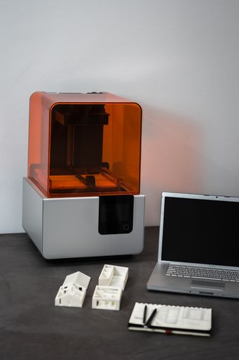 A 3D printer laptop mass model on an office table
