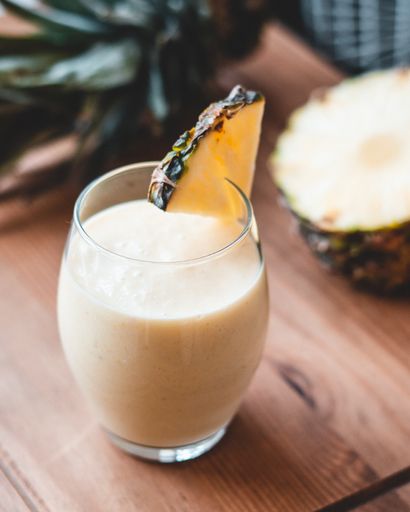 Food photography pineapple, mango, coconut milk smoothie in a glass