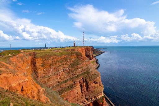 A breathtaking scenery of industrial buildings on the edge of the rocky seashore