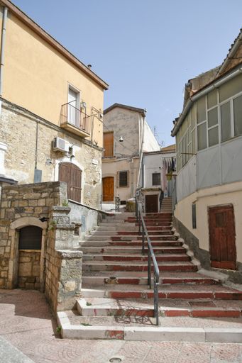 A vertical of old beautiful stone buildings and narrow streets in Candela village in Puglia, Italy