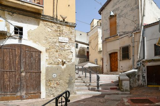 A scenic view of old beautiful stone buildings and narrow streets in Candela village in Puglia, Italy