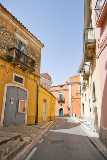 A vertical of old colorful buildings and narrow streets in Candela village in Puglia, Italy