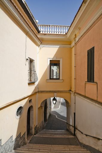 A vertical shot of a small street between the old houses of Candela, a mediterranean village of Puglia region, Italy