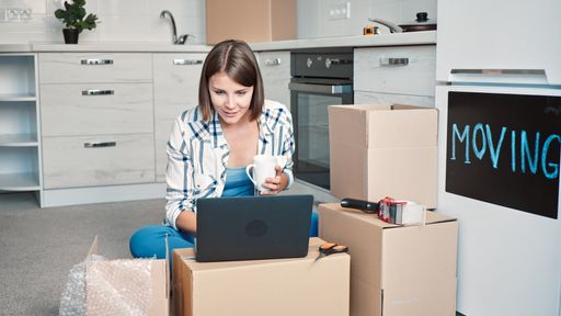 A closeup shot of a Caucasian woman working with her computer in home