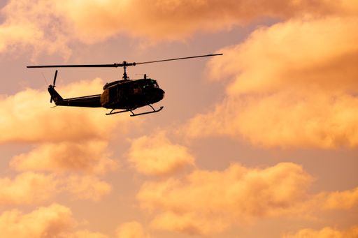The silhouette of the helicopter in the beautiful sky at sunset.