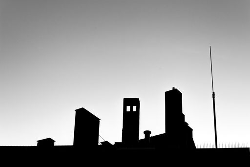 A low angle silhouette of buildings under cloudless clear sky