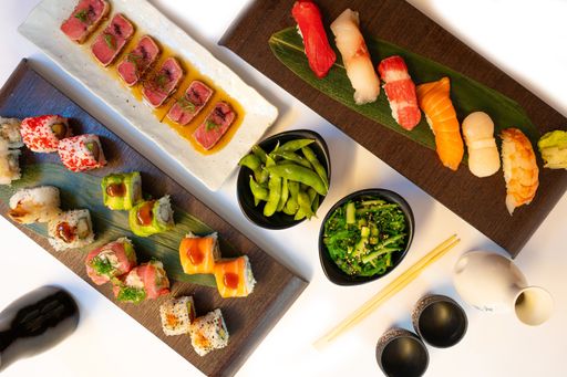 A top-view of traditional Japanese food with sushi, nigiri and tuna with salads, tuna tataki