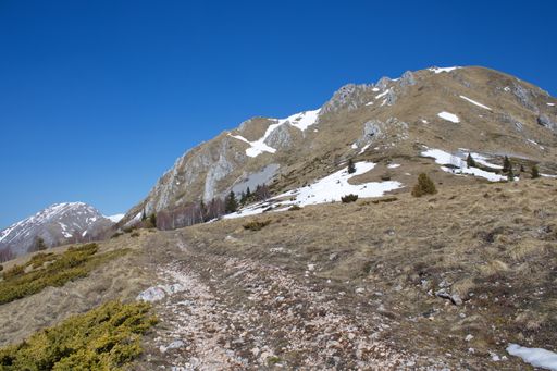 A scenic view of alps mountains under a blue sky