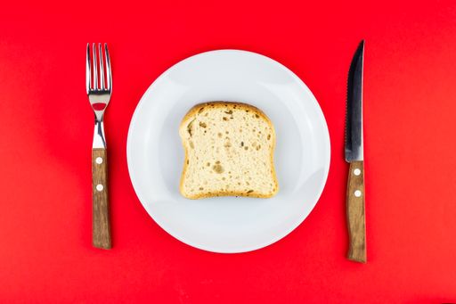 A top view of a single slice of bread for lunch (concept of being poor)
