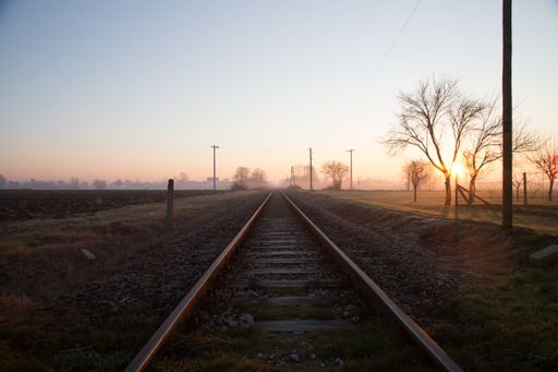 A scenic view of an old railway in the countryside during a foggy morning