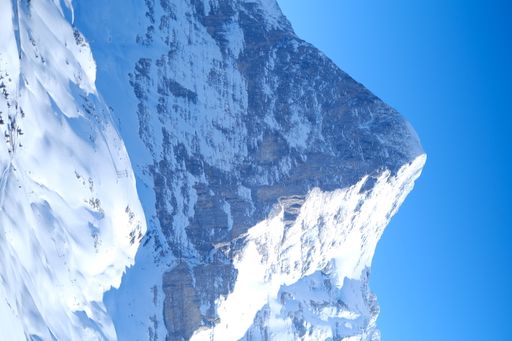 A beautiful shot of snowy Wengen mountains Ski in Grindelwald, Switzerland with a blue sunny sky