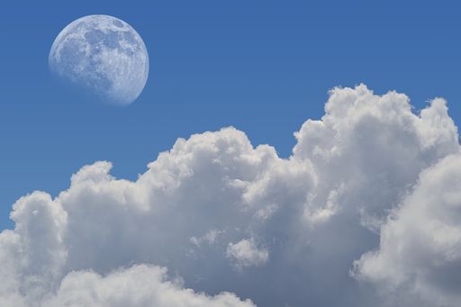 A mesmerizing landscape shot of the moon vibrant on broad day light