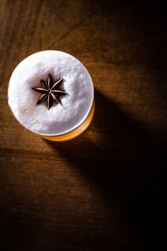 A vertical top shot of a refreshing cocktail on a wooden table.