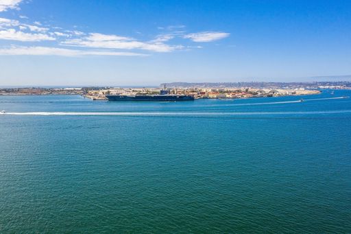 An aerial shot of a big ship near the harbor in the sea