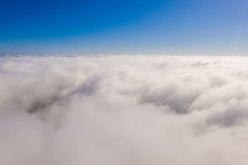 Beautiful view of the sky above the clouds from airplane window