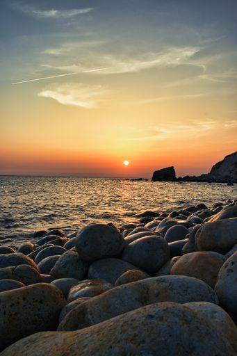 A vertical shot of rocks on the seacoast at sunset, Isle of Wight