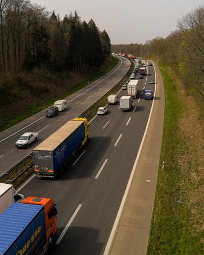 A vertical shot of a road with trucks and passenger cars, Germany