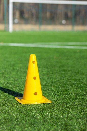 vertical shot of a cone on a football arena, selective focus