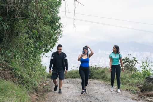 A beautiful shot of three young Latinos walking through the mountains of the coffee axis in Colombia-Risaralda during daytime