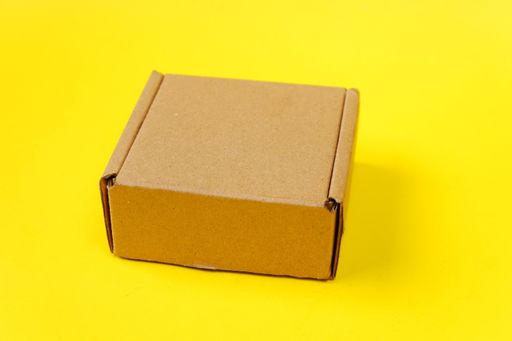 A closeup shot of a gift box on a yellow background