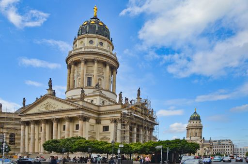 A beautiful shot of the German church at Gendarmenmarkt square against blue sky on a sunny day in Berlin, Germany.