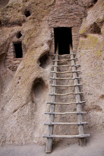 A vertical shot of a ladder leading to a cliff dwelling at the Bandelier National Monument, New Mexico