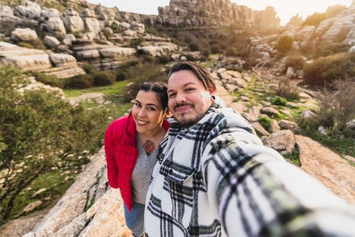 A beautiful shot of a Caucasian couple taking a selfie on a sunny day in El Torcal de Antequera, Malaga, Spain