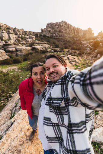 A beautiful shot of a Caucasian couple taking a selfie on a sunny day in El Torcal de Antequera, Malaga, Spain