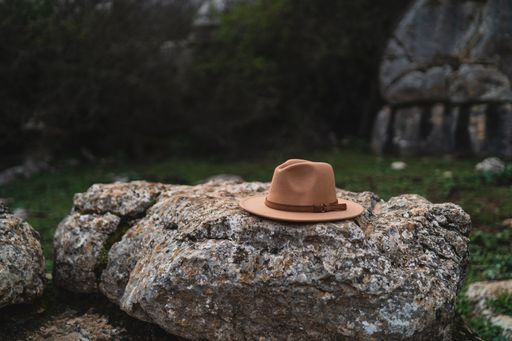 A close-up shot of a hat on a rock during daytime with blurred background in El Torcal de Antequera, Malaga, Spain