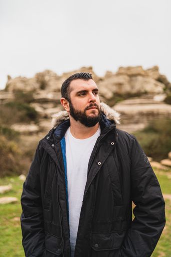 A portrait of an adult Caucasian man standing in El Torcal de Antequera during daytime, Malaga, Spain
