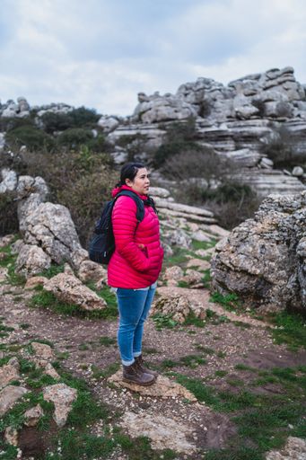 A beautiful shot of an adult Caucasian woman standing in El Torcal de Antequera on a sunny day, Malaga, Spain
