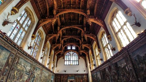 The magnificent Hampton Court hall impresses with its size, beauty of the ceiling, and stained glass windows