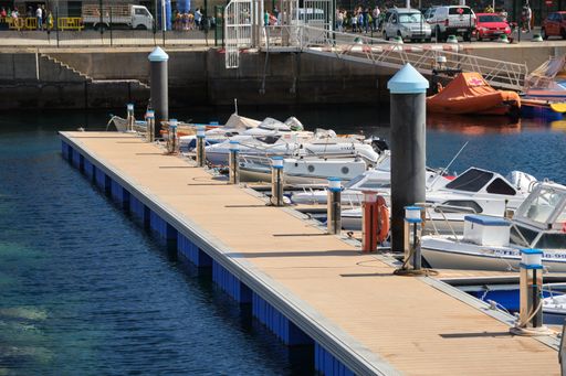 Floating dock with small boats in the harbor of Puerto de la Estaca on El Hierro. Boat trip in the sea reserve on the Canary Islands.