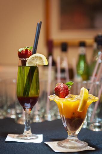 A vertical shot of two glasses of classical cocktail drinks on a table