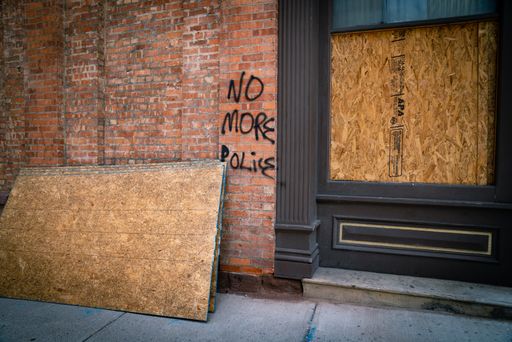 A boarded up store and anti-police graffiti following race riots after the death of George Floyd in Albany, New York