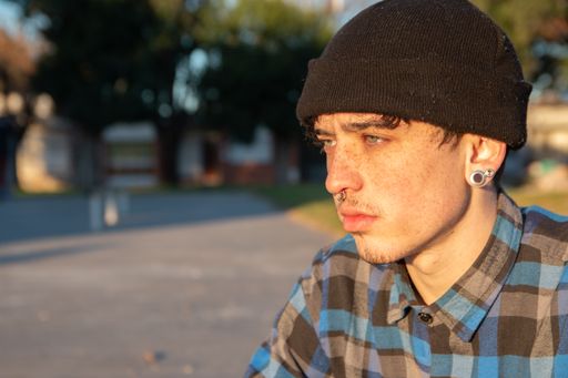 A closeup shot of a Portrait of a freckled caucasian handsome blue-eyed teenager boy