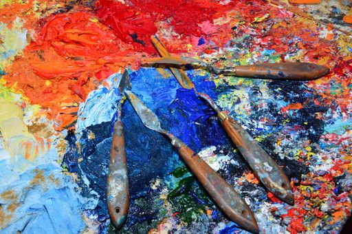 A painter's palette with brushes in the workplace