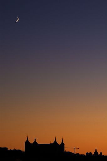 A vertical shot of the silhouette of the fortress of Alcazar at sunset, Toledo, Spain
