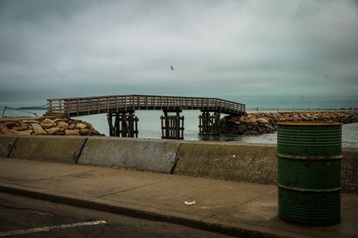 The Plymouth Rock jetty wooden bridge against cloudy sky
