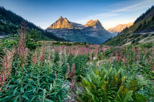 A photo of the sun hitting the mountain peaks in Glacier National Park, Montana