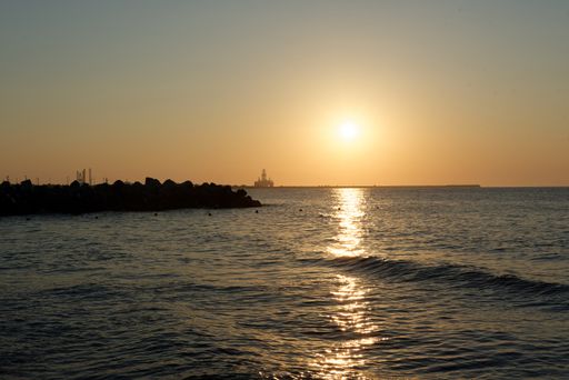 A beautiful view of the sea with splashing waves at sunset
