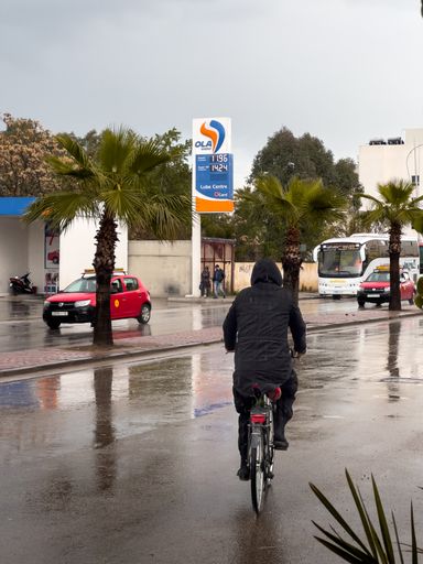 Man riding his bike during a rainy day