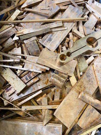 Brass scrap plate offcuts rejects from a manufacturing process. High quality photo