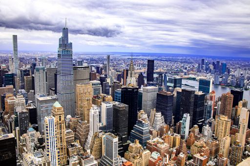An aerial shot of New York city skyline  from Empire State Building under a cloudy sky