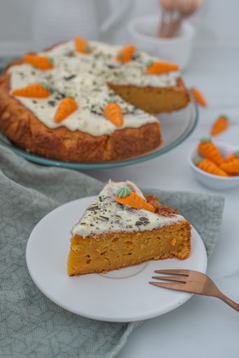 A vertical shot of carrot cake with cream cheese frosting
