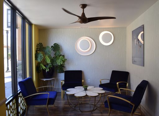 A room with mixed retro and modern interior design with chairs and a table in the century